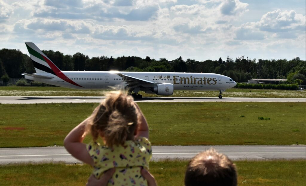 Child watching airplane leave for overseas. OFW.